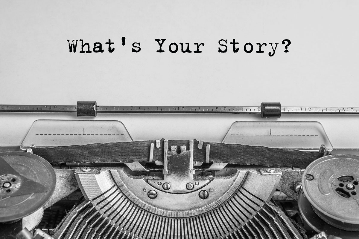 In a striking black and white image of an old typewriter, a sheet of paper prompts with "What's Your Story?" suggesting the introspective journey therapy in NYC often embarks upon. The typewriter's mechanical intricacies are beautifully captured at the bottom.